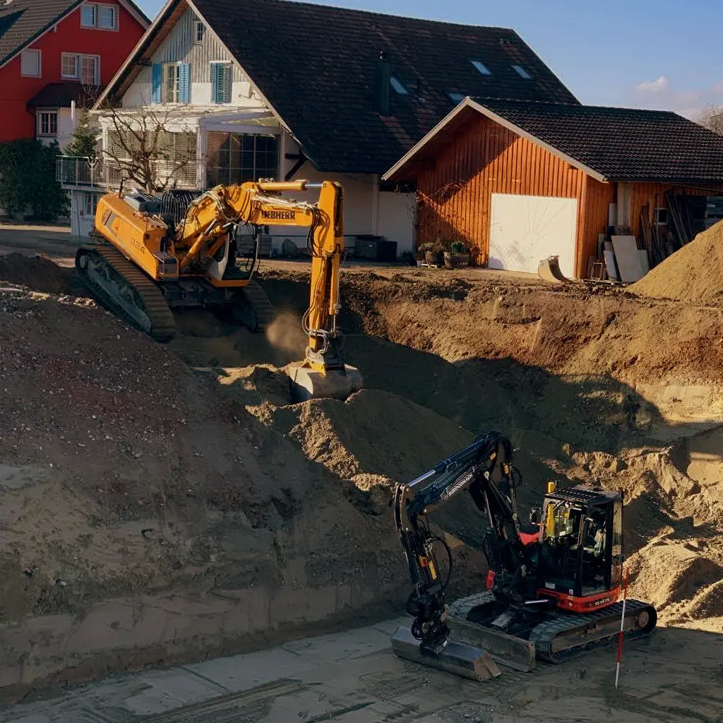 Bagger mit Rammtechnik in enger Baugrube